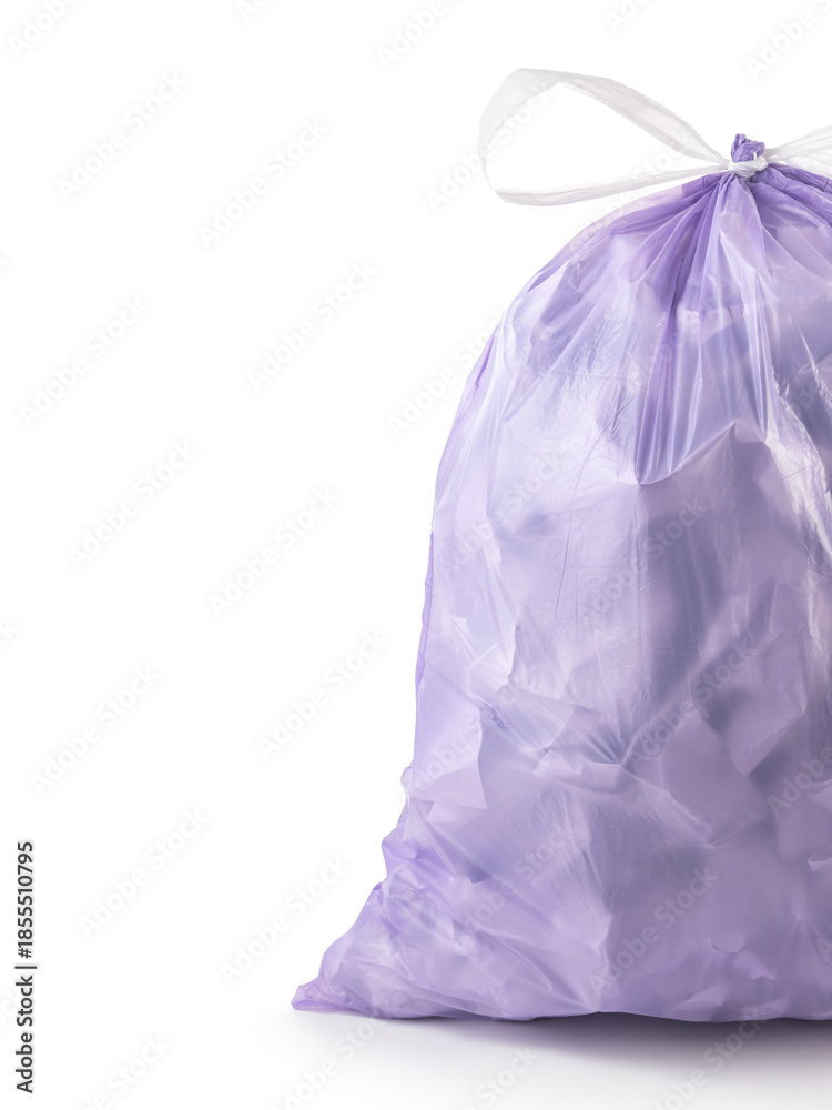 Fototapeta premium Close-up. Vertical photo of a purple tied trash bag filled with crumpled paper. Advertising, copyspace..