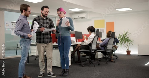 Wallpaper Mural Team members discuss project details in an office setting during a working session with focus on collaboration and planning at midday Torontodigital.ca