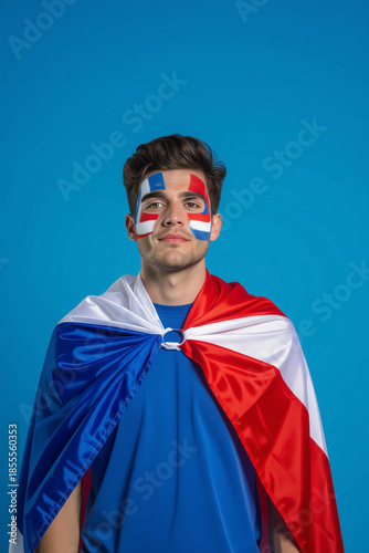 A passionate fan is wrapped in the flag of his nation, proudly sporting face paint in the vibrant colors, radiating national pride.