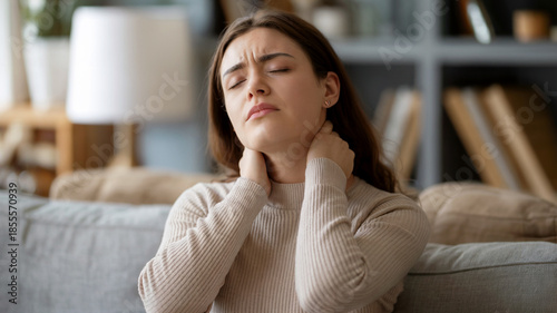 Woman Suffering Neck Pain at Home on Sofa