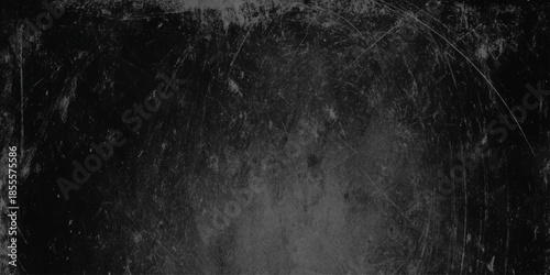 A textured dark grayscale background featuring scratches smudges and subtle variations in tone and light