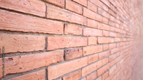 Old red brick wall. Red brick wall perspective view with selective focus.