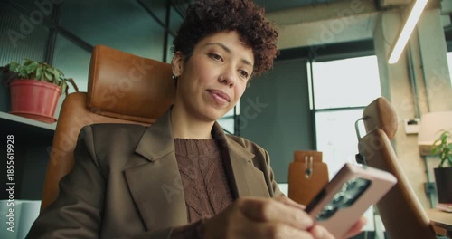An African woman managing team tasks from her workspace location