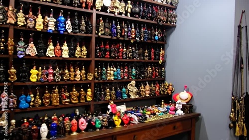 Wallpaper Mural A collection of various small sculptures displayed on shelves and tabletop, featuring varied colors and shapes Torontodigital.ca