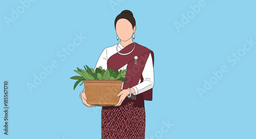 Woman in traditional southeast asian costume holding a woven basket filled with green leaves against a blue sky.
