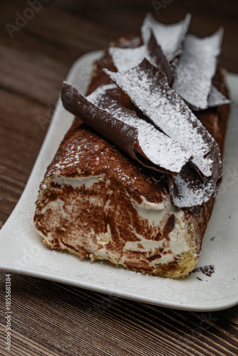 Tiramisu Tronchetto Dessert, Italian Yule Log Christmas dessert with chocolate bark, High quality photo