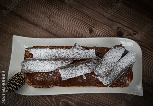 Tiramisu Tronchetto Dessert, Italian Yule Log Christmas dessert with chocolate bark, High quality photo