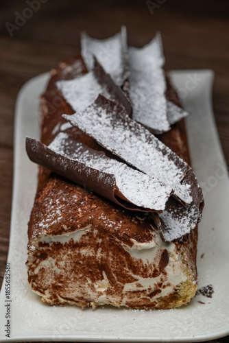 Tiramisu Tronchetto Dessert, Italian Yule Log Christmas dessert with chocolate bark, High quality photo