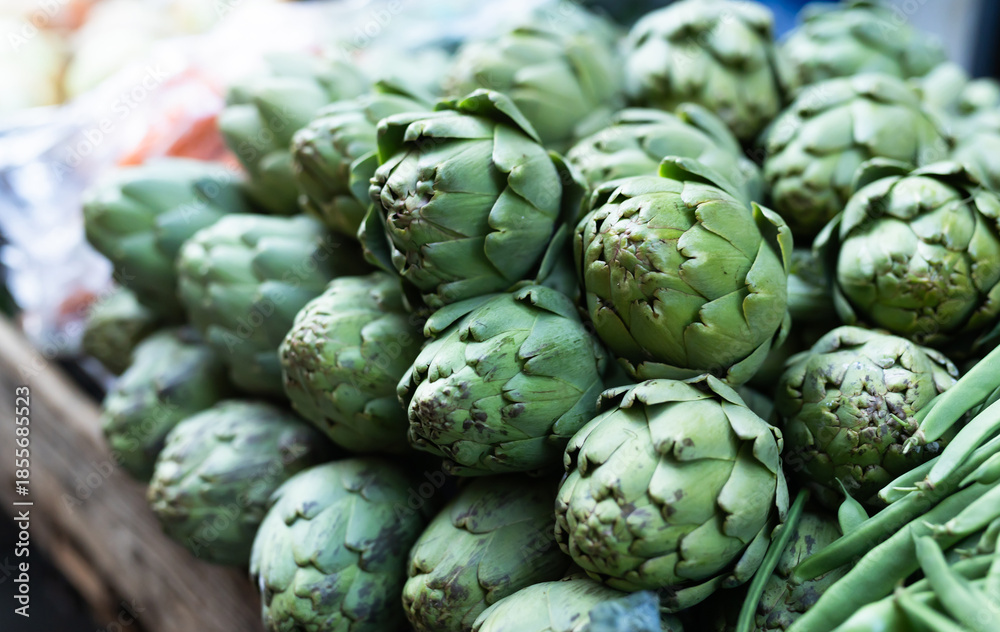 Fototapeta premium Pile of artichokes displayed on market counter