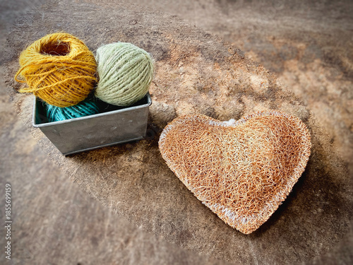 Luffa heart shape,and thread basket put on vintage wooden board,