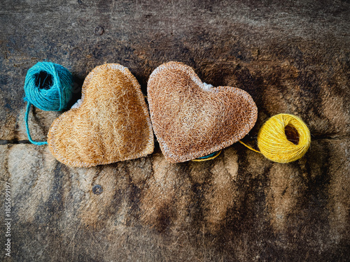 Luffa heart shape,texture is coarse and fibrous.put on vintage wooden board,blurry light around