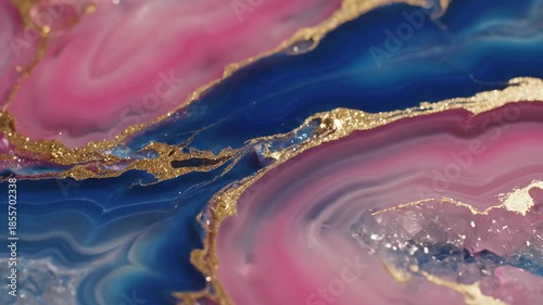 Extreme slow motion macro view of colorful pink and blue agate swirls detailing liquid marble texture separated by shimmering gold trim liquid, fluid, motion