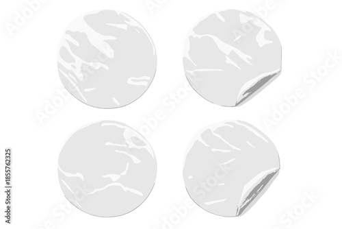Four white round stickers on a grey background