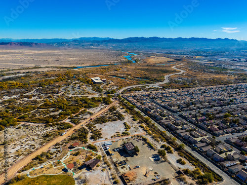 Aerial view of suburban residential neighborhoods and arterial roads in Los Angeles under clear blue sky