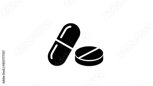Black pills and capsules on a white background