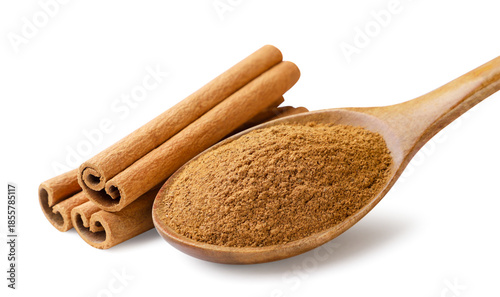 Cinnamon powder in a wooden spoon and cinnamon sticks on a white background. Isolated