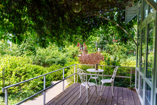 Outdoor seating area near greenery in sunny weather