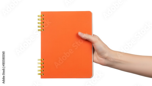 Quadro em tela Isolated orange notebook being held by a hand, showcasing the bright cover with