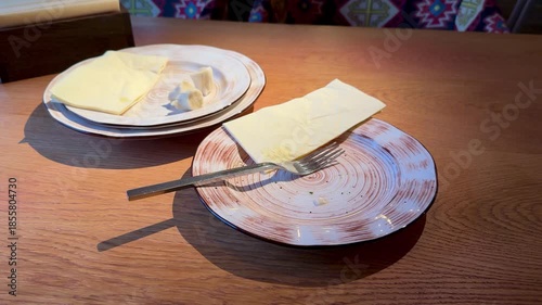 Simple Rustic Display, Barren Wooden Plate With Utensils, Minimalist Wood Plate Complemented By Rustic Ceramic Elements, Calm Intimate Table Setting Featuring Wooden Plate And Warm Lighting