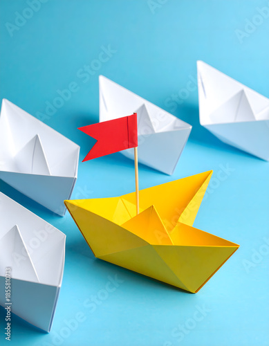 Yellow Paper Ship with Flag Standing Out from White Boats - Teamwork Concept
