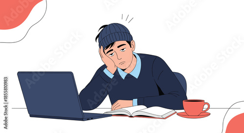 Exhausted and bored young man in a beanie sits at his desk with a laptop feeling sleepy and unmotivated while studying hard.