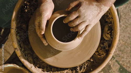 Top-down mid-shot of a man doing pottery