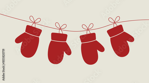 Red mittens hanging on a festive holiday line with bows