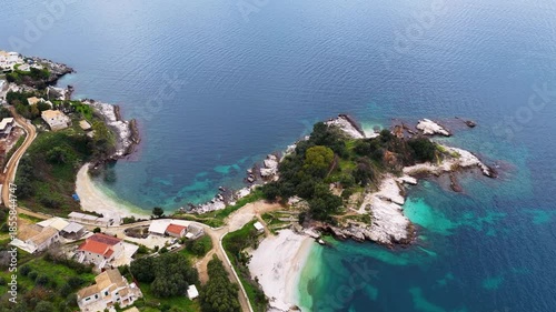 Top Down Aerial View of Exotic Turquoise Bay with White Pebble Beach and Rocky Peninsula