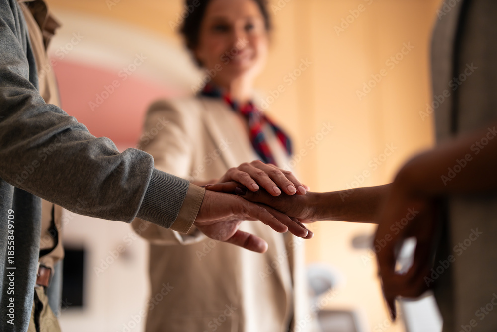 Obraz premium Warm Teamwork And Unity As Hands Stack Together In A Friendly Office Setting