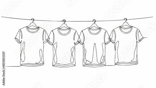 Four T-shirts hanging on a clothesline with hangers.