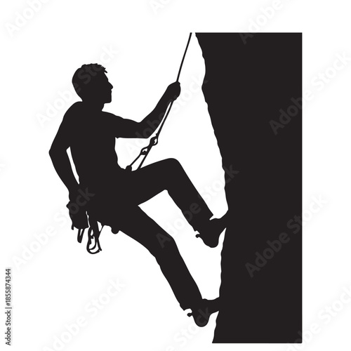 Silhouette of an adventurous man rock climbing or rappelling on a rugged cliff