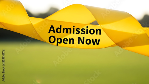 Yellow ribbon with Admission Open Now text blurred green background