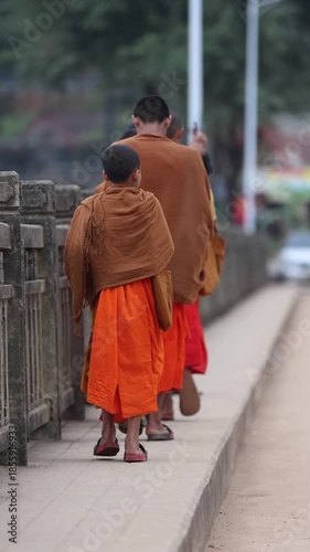 A stylish mother and father enjoy a summer lifestyle walking outdoors in the city park with their happy child and family while shopping together in the street