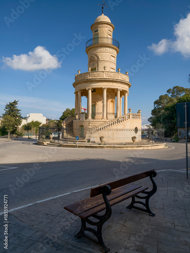 Lija, Malta — historic rotunda in a sunlit town square with colonnade and surrounding limestone facades