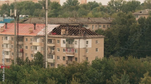dismantling the roof of an old brick house