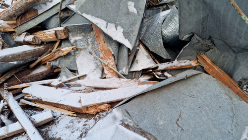 Garbage dump. Close-up of a demolished wooden house in the snow. Winter background. 
Environmental pollution.
