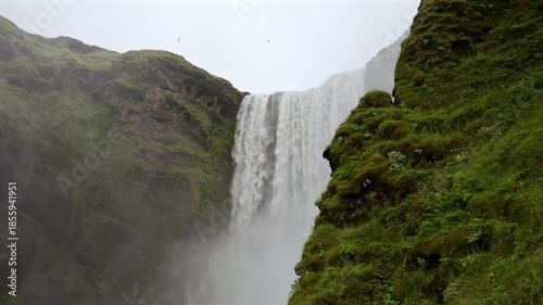 Waterfall Falling Between Mossy Cliffs