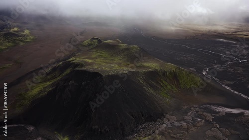 Misty Volcanic Landscape with Black Slopes Helicopter View
