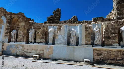 SIDE, TURKEY, June 16, 2024: Ruins of the ancient city of Side in Antalya province on the Mediterranean coast. Amazing ruins of an ancient city. Old statues in the State Agora.The ancient city wall.4K