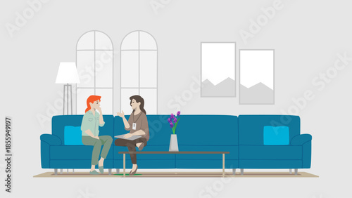 Two Working Women Sitting in Blue Couch Sofa Talking Advising with Greyish Color Background