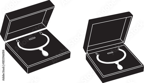 Two black jewelry boxes displaying elegant necklaces a minimalist design