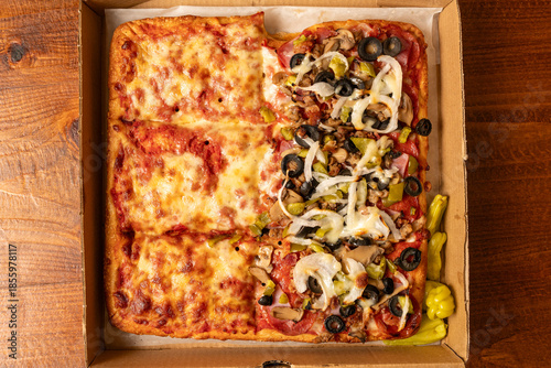 Sicilian pizza half with onions and olives and half plain