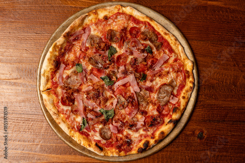 Pizza with sausage, bacon and ham