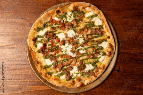 Pizza with sausage and pesto sauce