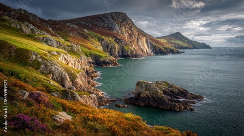Cliffs and coastline with vibrant colors and cloudy skies at the coast in a scenic location during the afternoon