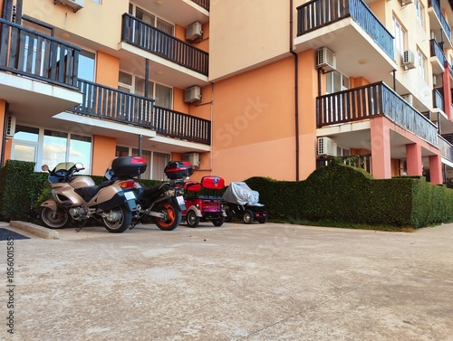 photography of motorbikes parked outside a building high quality horizontal image perfect for campaigns
