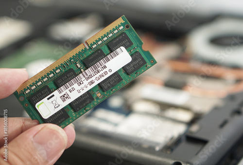 Technician Holding Laptop RAM Module for Replacement