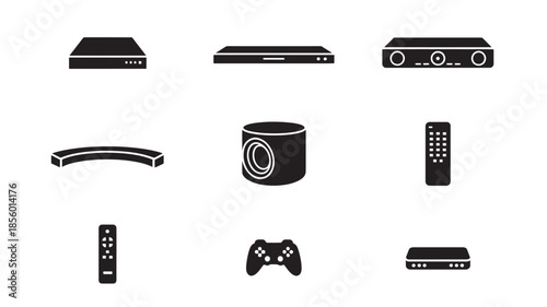Collection of electronic devices including gaming console, remote controls, and audio equipment displayed on a plain white background.
