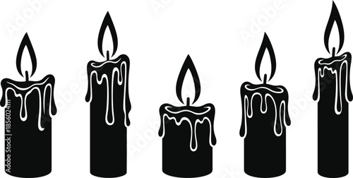 Five black candles with melting wax and flames