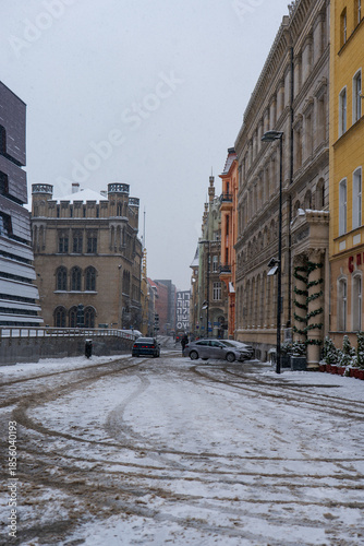 Winter street in Wroclaw with Neo Gothic tower and pastel facades